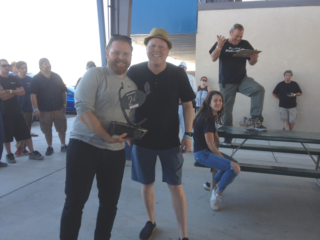 The Organizer’s Choice Award, with the organizer questioning his choice in the background